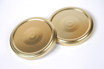 Screw caps for glass jars. For canning, canned food. Golden caps on white background