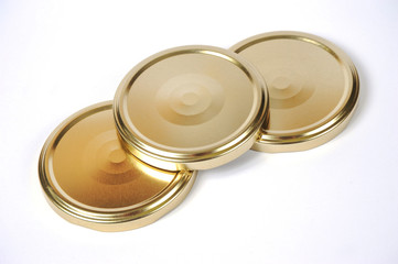 Screw caps for glass jars. For canning, canned food. Golden caps on white background