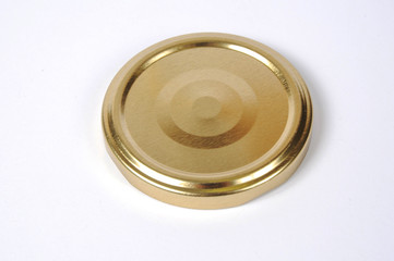 Screw cap for glass jars. For canning, canned food. Golden cap on white background