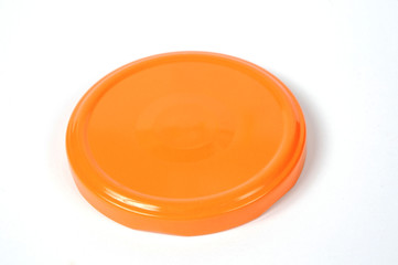 Screw cap for glass jars. For canning, canned food. Orange cap on white background