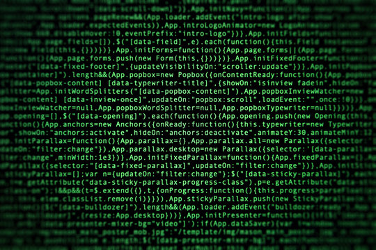 Software source code on dark background. Programming javascript code on computer screen. Console on real retina screen with pixels visible. Front view with vignette effect