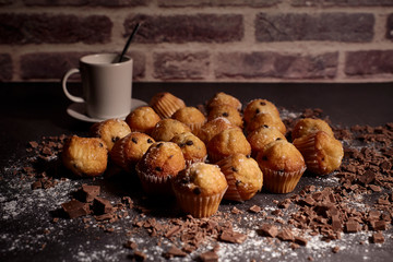 group of muffins next to a cup of milk
