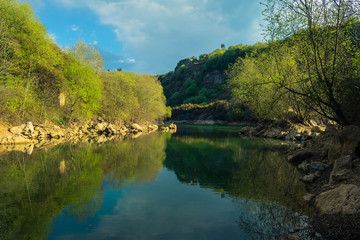 blue lake with many rocks around