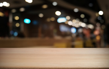 Empty dark wooden table in front of abstract blurred bokeh background of restaurant . can be used for display or montage your products.Mock up for space.