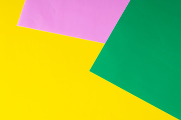 Multicolored horizontal background, colored cardboard. Yellow, green and purple. Copy space