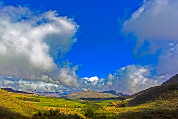 Wide-angle landscape of  mountains and clouds