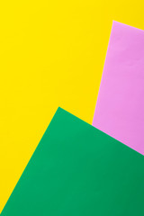 Multicolored vertical background, colored cardboard. Yellow, green and purple. Copy space