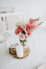 table decorated with compositions of pink flowers