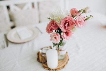 table decorated with compositions of pink flowers