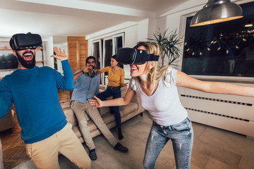 Fototapeta na wymiar Young couple having fun with virtual reality headset glasses - Happy people playing game with new trends technology