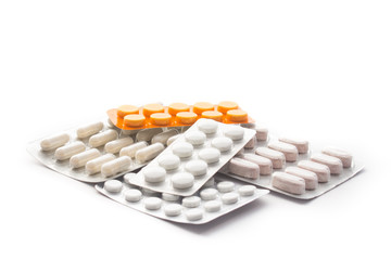 Closeup capsule and pills in blister pack isolated on the white background. Different tipes of pills. Pharmaceutical industry. Global healthcare. Pharmacy background.