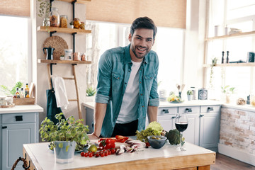 Taking care of his health. Handsome young man in casual wear looking at camera and smiling while...