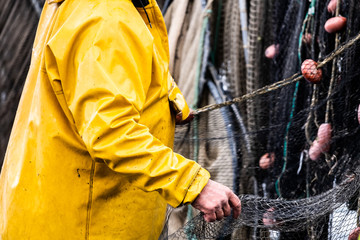 Pêcheur en train de ranger ses filets de pêche