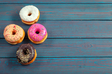 Glazed donuts on wooden background