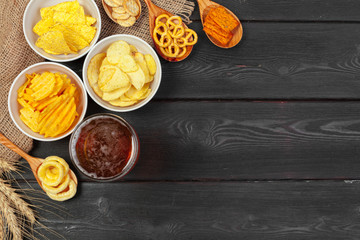Lager beer and snacks on wooden table.
