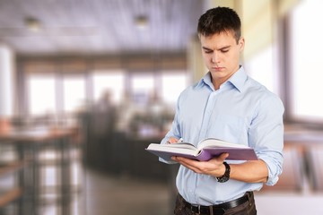 Young male teacher   standing with book