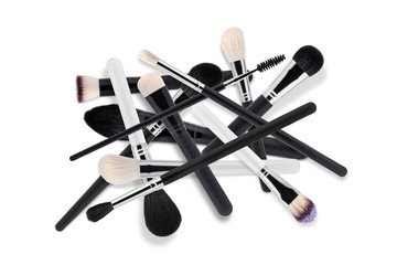 Different types of brushes for a make-up on a white background. Top view