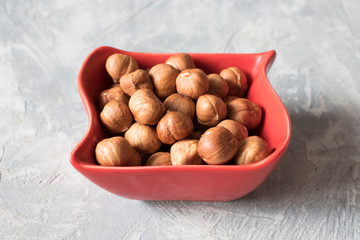 Healthy food and snack. nuts, hazelnuts in a red bowl