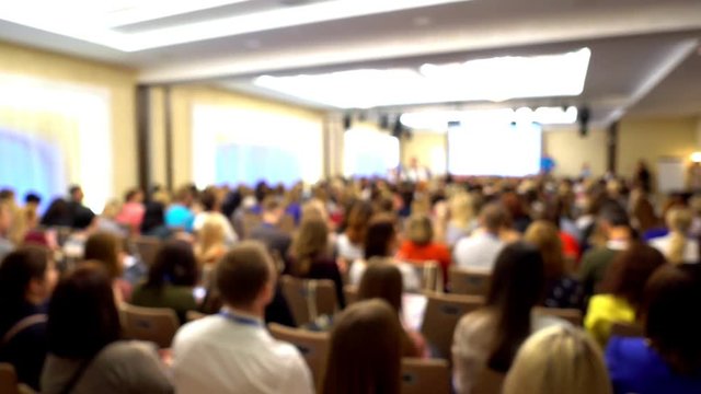 he woman with the smartphone in hands. People at a conference. Beautiful view.