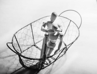 Concept of manipulation.  The figurine of a wooden man keeps the other for the purpose of...