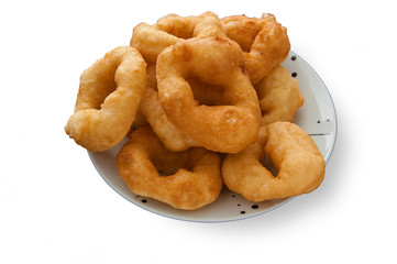 sweet cakes in the form of rings on a plate on a white background