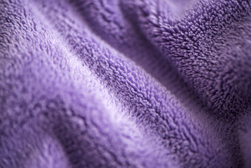 Lilac delicate soft background of fur plush smooth fabric. Texture of purple soft fleecy blanket textile