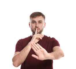 Man showing HUSH gesture in sign language on white background