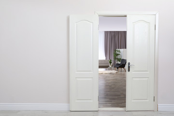 Stylish room interior, view through open door. Space for text