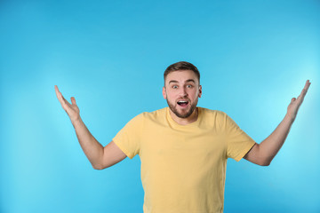 Fototapeta premium Portrait of emotional young man on color background