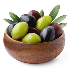 Delicious black, green and red olives with leaves in a wooden bowl, isolated on white background