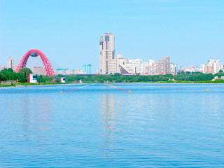 Naklejka premium Moscow, Russia, urban skyline with the Rowing channel Krylatskoe, the Picturesque Bridge and modern skyscrapers and houses. It is a sports complex for water sports, for rowing on kayaks and canoes.