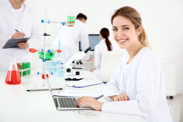 Medical student working with laptop in modern laboratory