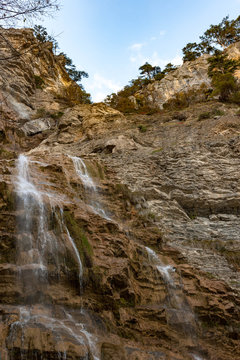 Beautiful view on Uchan-su waterfall that falls from the high rock mountain Ah-Petri in Crimea, Russia.