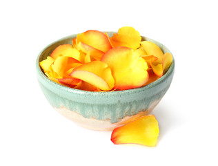 Bowl with rose petals on white background