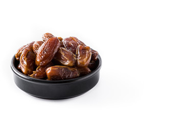Dates in black bowl isolated on white background. Copyspace