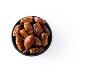 Dates in black bowl isolated on white background. Top view. Copyspace