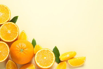 Flat lay composition with ripe oranges and space for text on color background