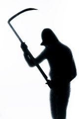 Dangerous man behind frosted glass with a scythe in his hand. Halloween. Black and white image.