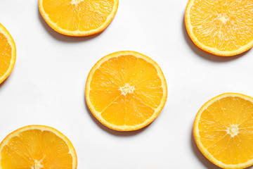 Composition with orange slices on white background, top view