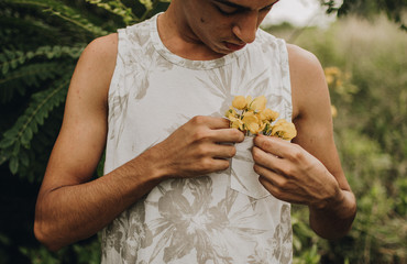 teenager in the garden picking yellow flowers