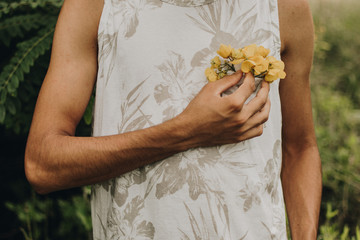 teenager in the garden picking yellow flowers