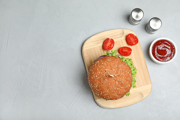 Flat lay composition with tasty burger on table. Space for text