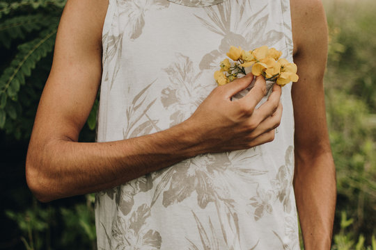 teenager in the garden picking yellow flowers