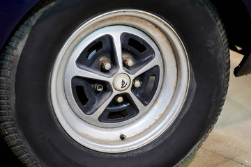 The wheel of a vintage American car. Powerful muscle cars