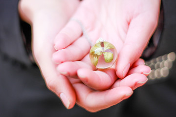 Model girl in a black jacket with a pendant of epoxy resin. Jewelry and costume jewelry. Handmade. Precious Making jewelry