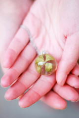 Model girl in a black jacket with a pendant of epoxy resin. Jewelry and costume jewelry. Handmade. Precious Making jewelry