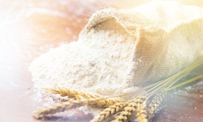 Wheat ears and flour on  background
