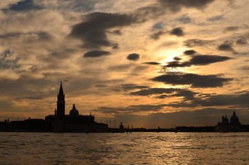a sunset with a building silhouette