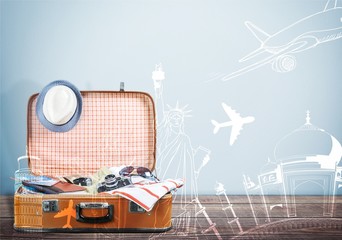 Travel bag on wooden floor and blue wall background