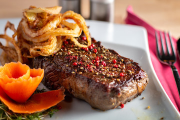 grilled steak with french fries and vegetables